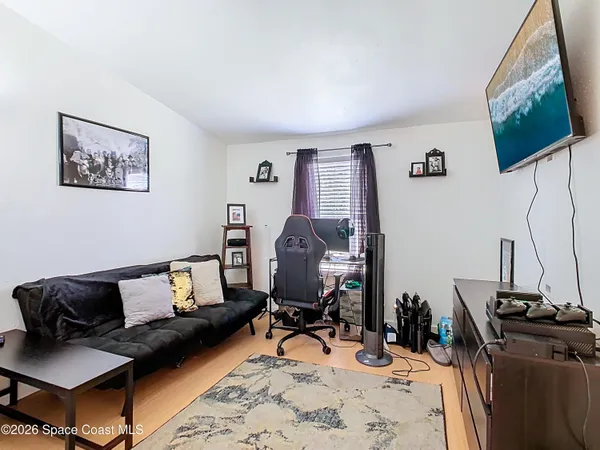 a living room with furniture and wooden floor