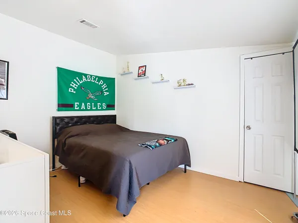 a bedroom with a bed and a chandelier