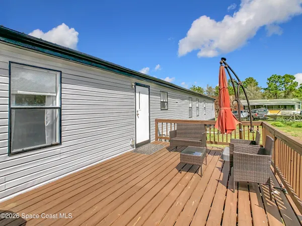 a view of a house with wooden deck