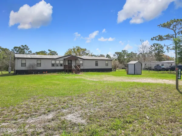 a view of a house with a big yard