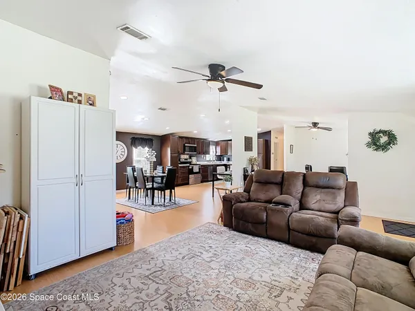 a living room with furniture and kitchen view