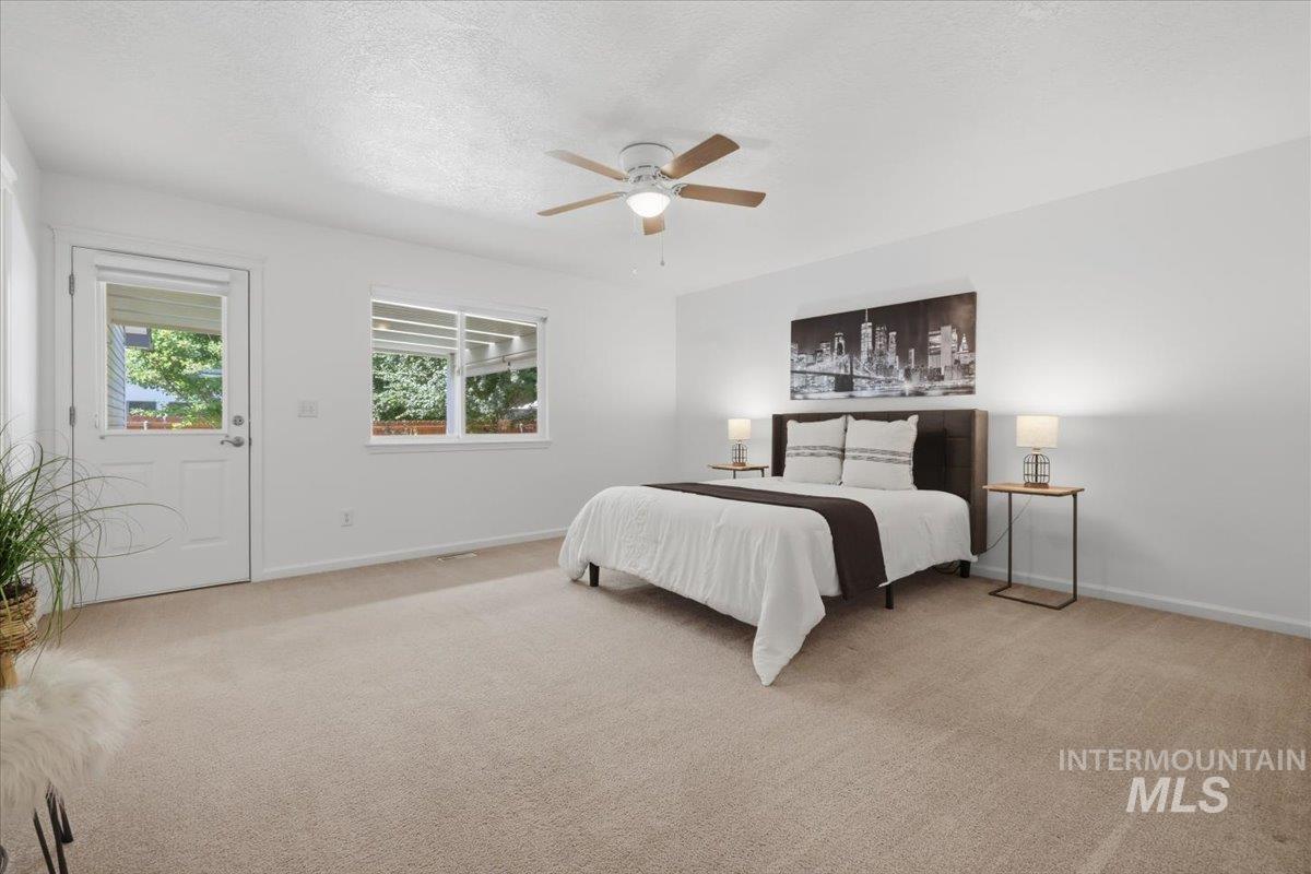 2075 North Springland Place Boise, ID 83713 - Photo 20 of 49 Spacious room with plush carpeting, white walls, and a ceiling fan
