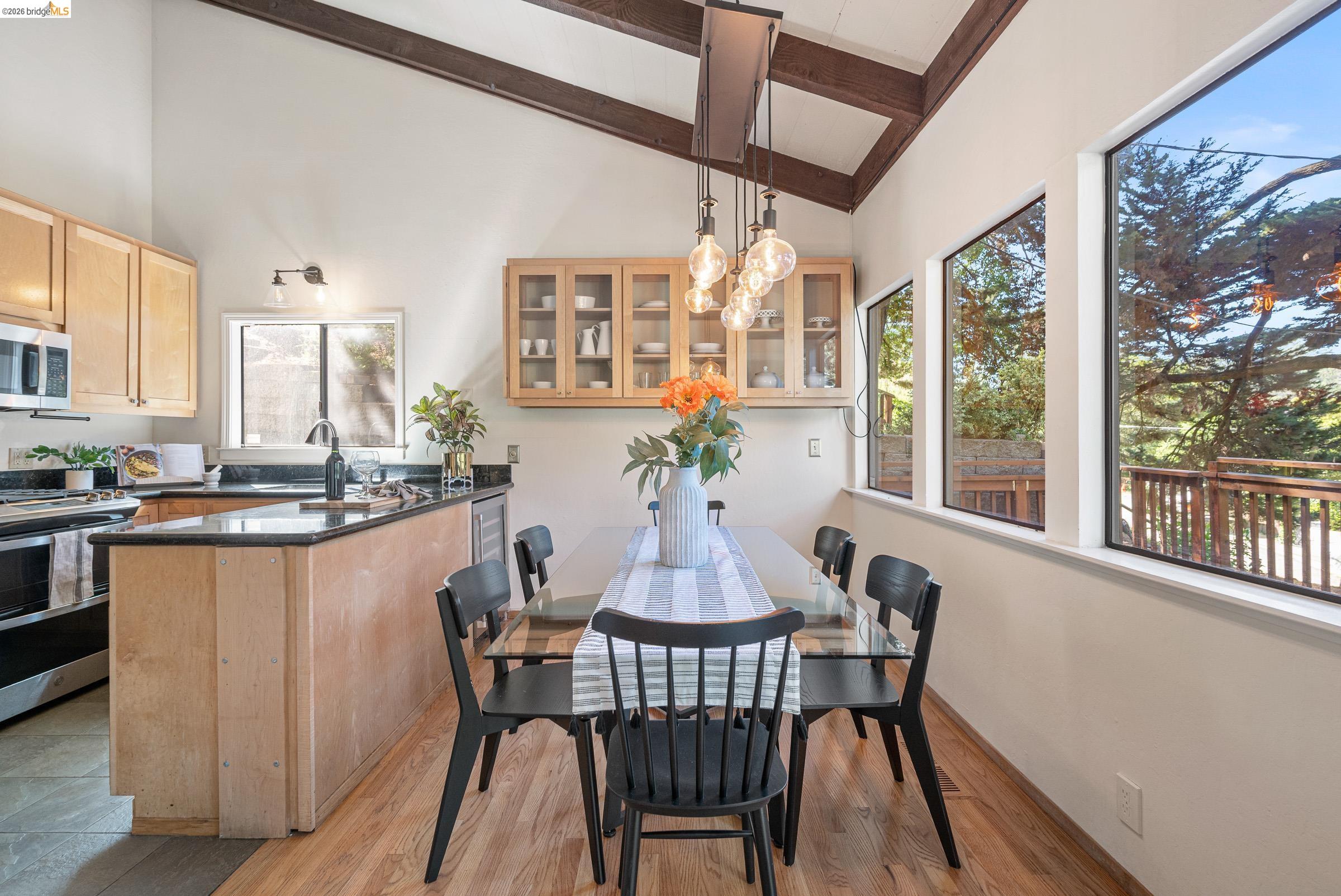 6600 Heather Ridge Way Oakland, CA 94611 - Photo 15 of 66 Open-concept living space with vaulted ceilings featuring exposed wood beams