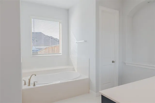 a white bath tub sitting next to a white sink