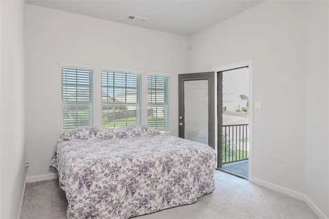 a bed sitting in a bedroom next to a window