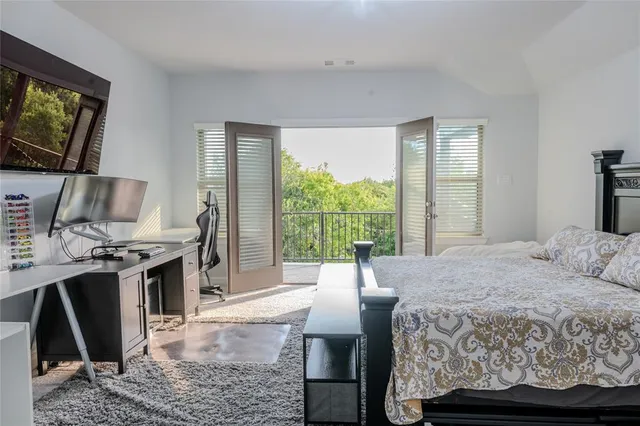 a bedroom with a bed and glass windows