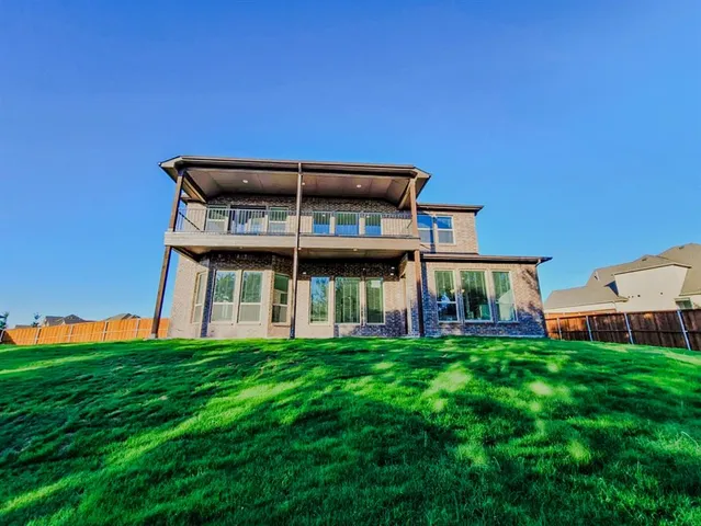 a view of a house with a yard and sitting area