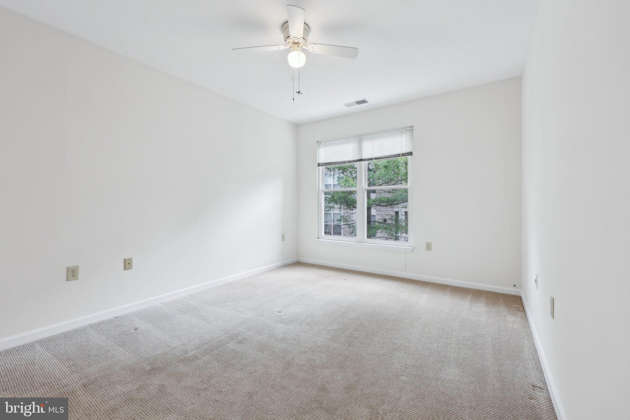 12919 Alton Square, Unit 302 Herndon, VA 20170 - Photo 13 of 21 an empty room with a window and ceiling fan