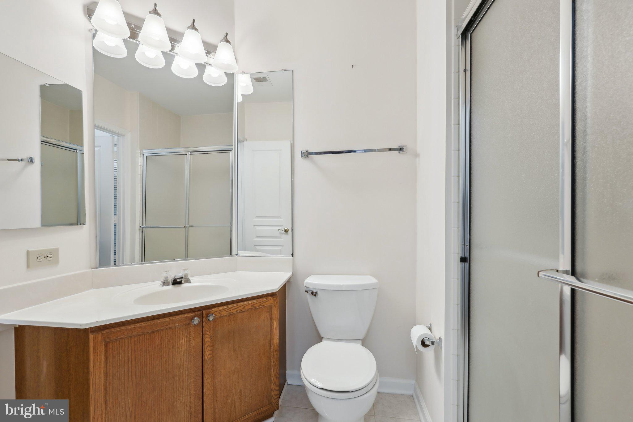 12919 Alton Square, Unit 302 Herndon, VA 20170 - Photo 14 of 21 a bathroom with a sink a toilet and a mirror