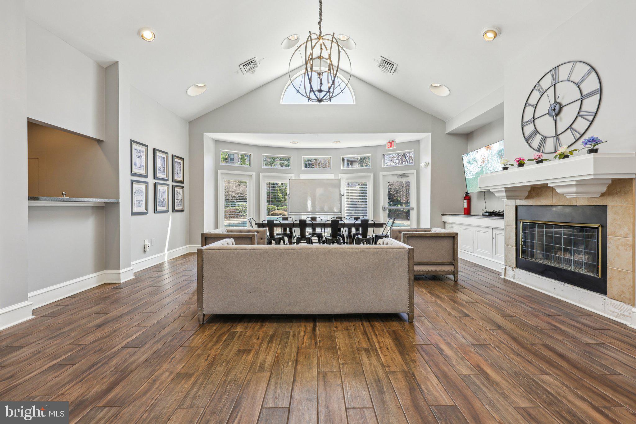 12919 Alton Square, Unit 302 Herndon, VA 20170 - Photo 17 of 21 a living room with furniture a fireplace and a ceiling fan