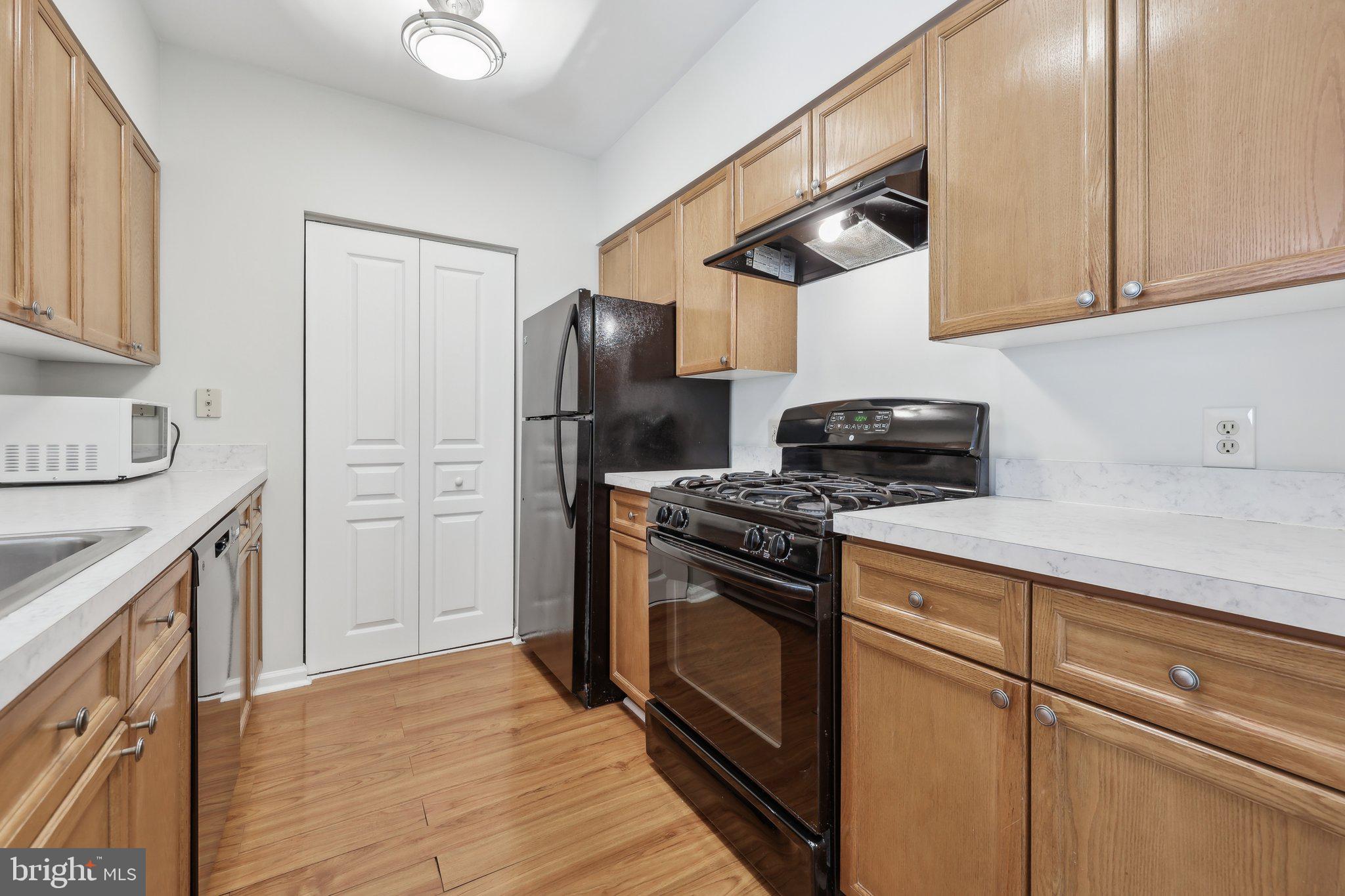12919 Alton Square, Unit 302 Herndon, VA 20170 - Photo 5 of 21 a kitchen with stainless steel appliances granite countertop a stove a refrigerator and a sink