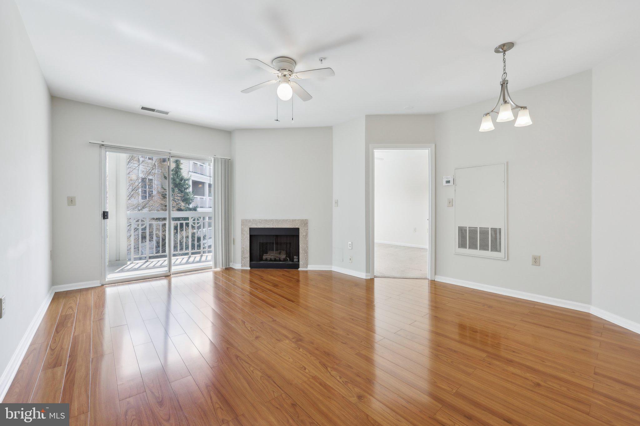 12919 Alton Square, Unit 302 Herndon, VA 20170 - Photo 6 of 21 a view of an empty room with wooden floor and a window