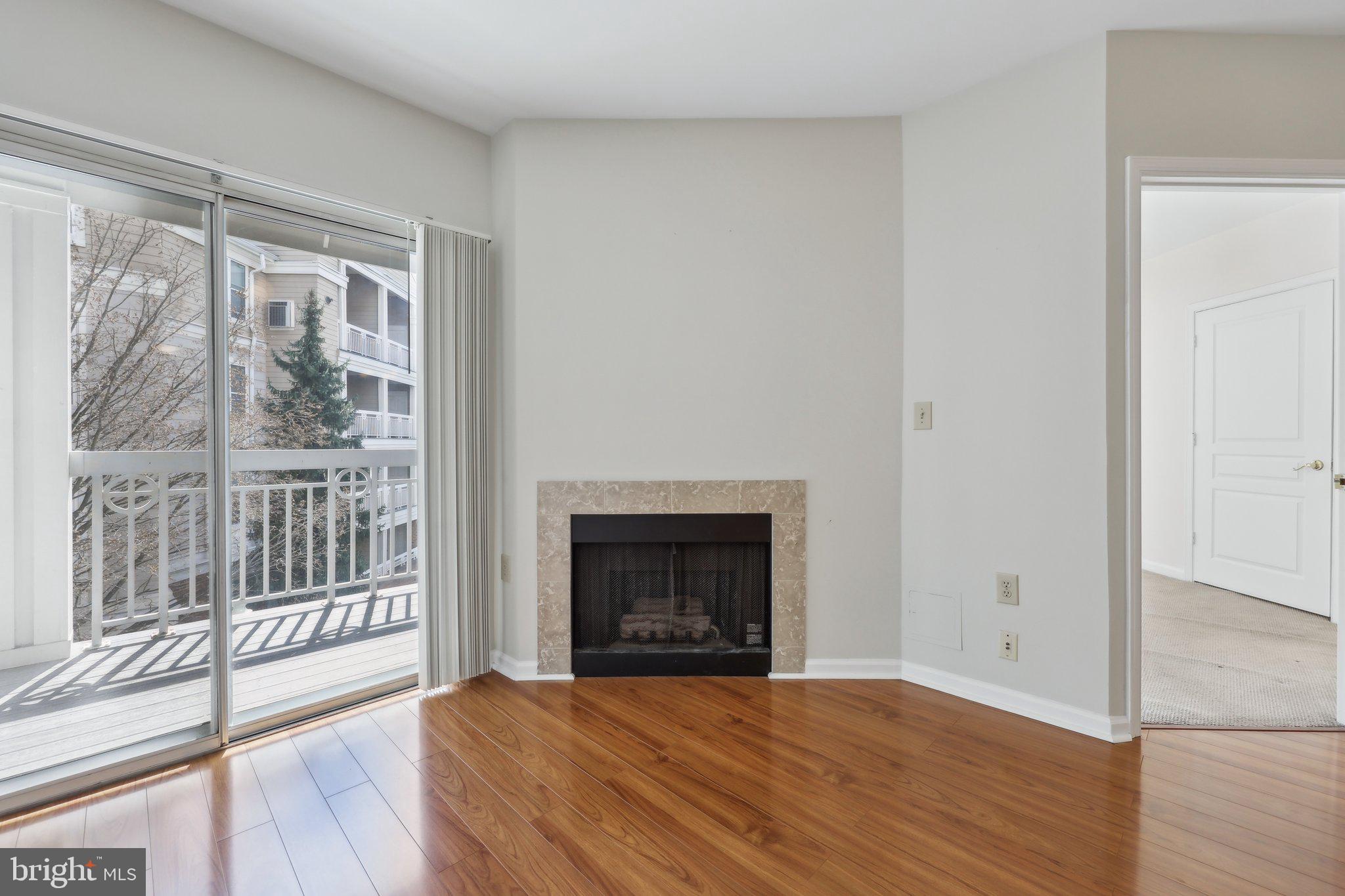 12919 Alton Square, Unit 302 Herndon, VA 20170 - Photo 7 of 21 a view of an empty room with wooden floor and a window