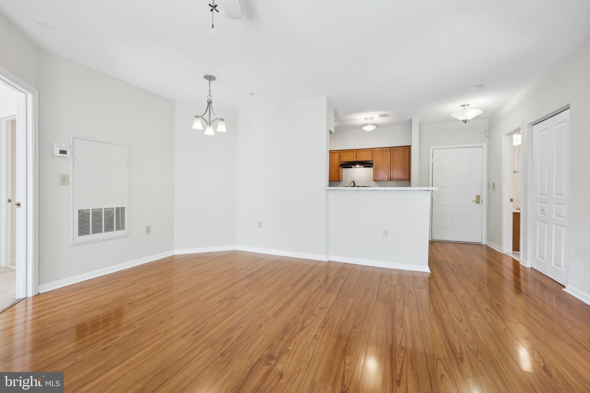 12919 Alton Square, Unit 302 Herndon, VA 20170 - Photo 9 of 21 a view of an empty room with wooden floor and a window