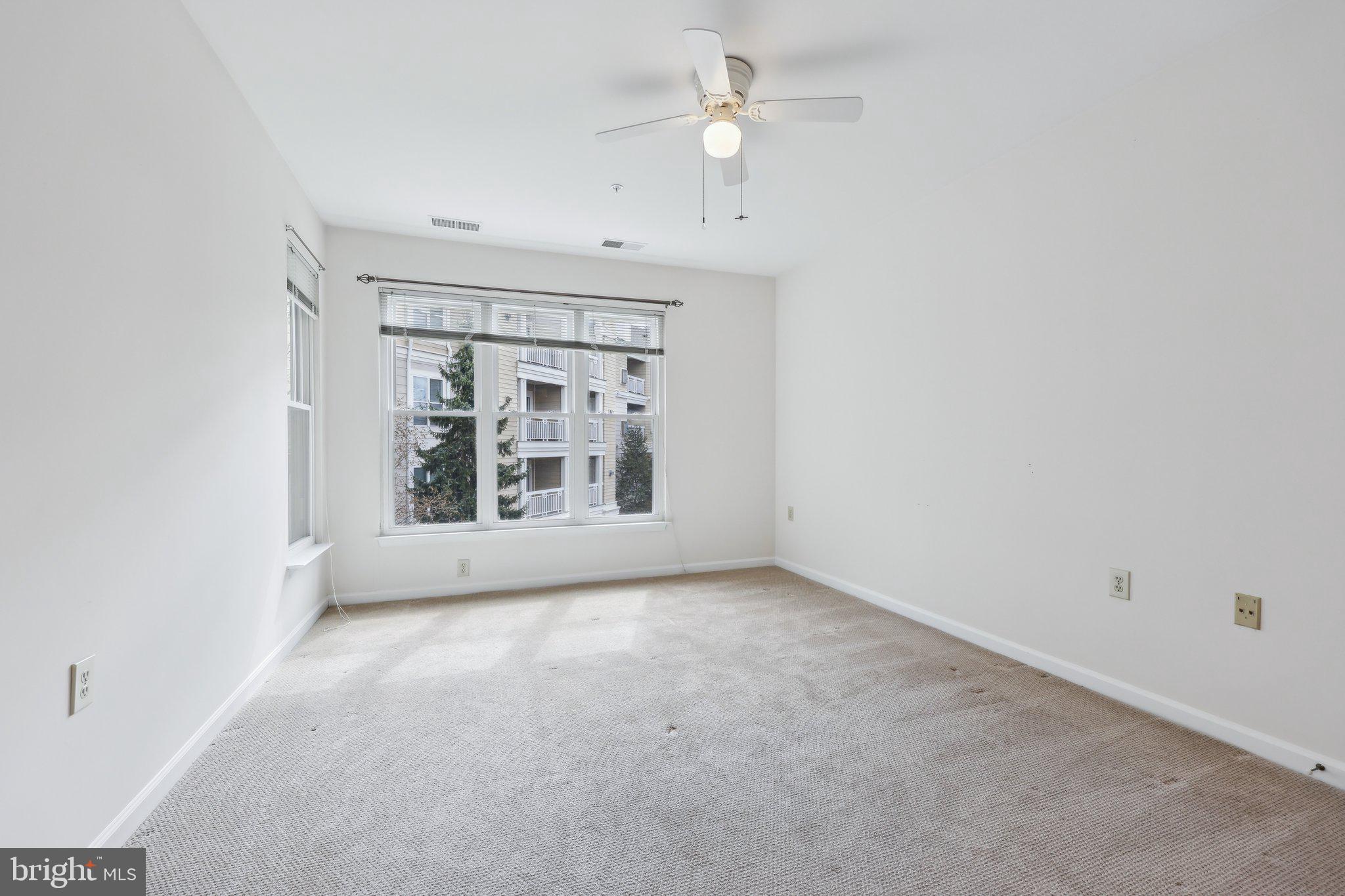 12919 Alton Square, Unit 302 Herndon, VA 20170 - Photo 10 of 21 an empty room with a window and a ceiling fan