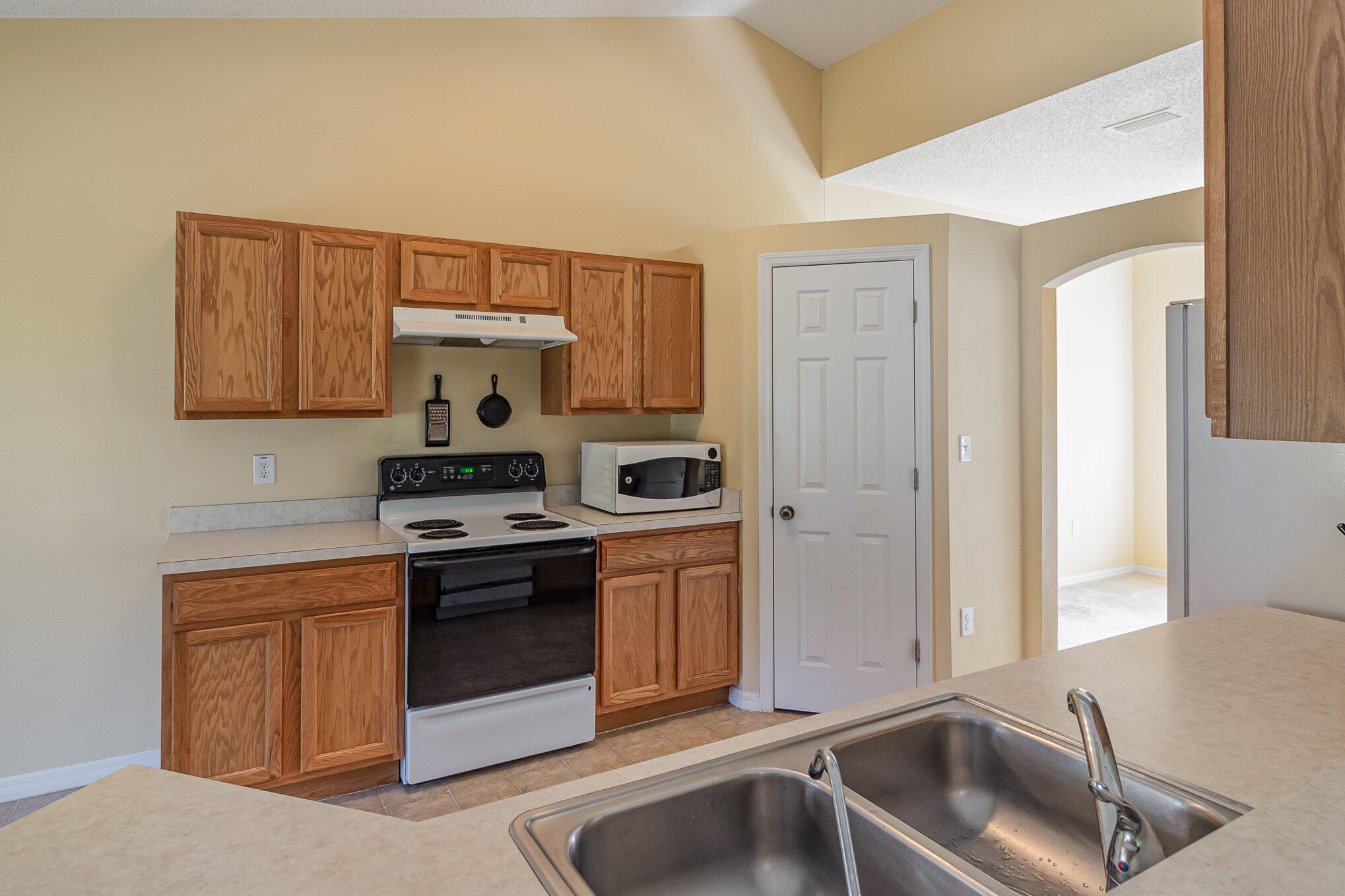 1391 Saxony Road Southwest Palm Bay, FL 32908 - Photo 13 of 28 a kitchen with a stove and a sink