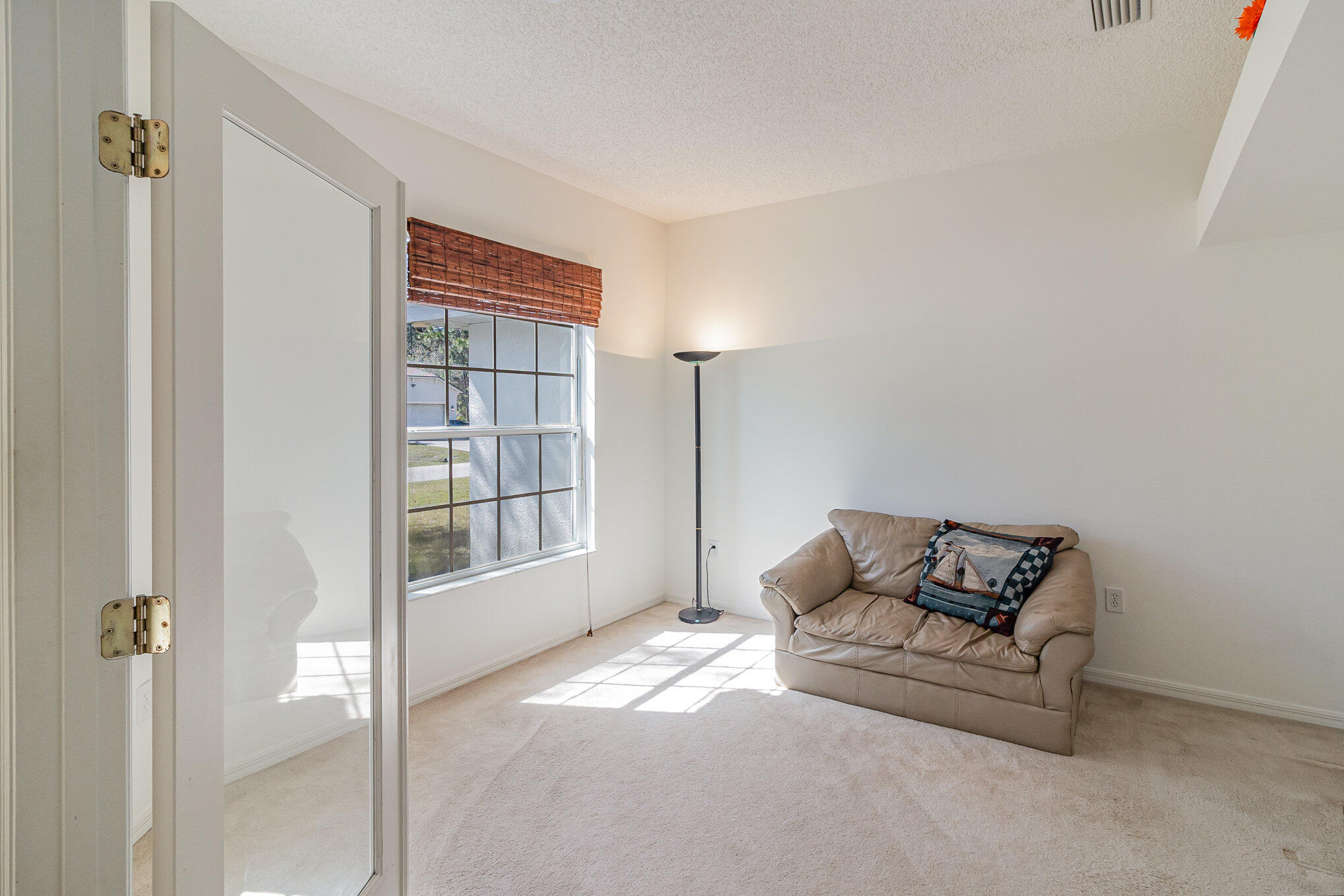 1391 Saxony Road Southwest Palm Bay, FL 32908 - Photo 14 of 28 a living room with furniture and a window