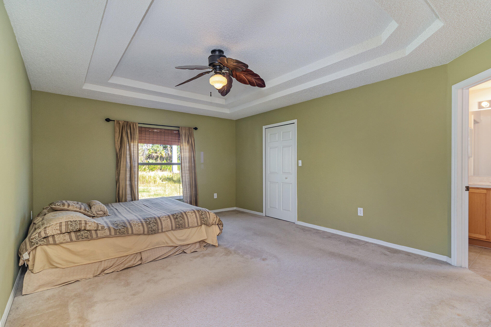 1391 Saxony Road Southwest Palm Bay, FL 32908 - Photo 15 of 28 a bedroom with a bed and window