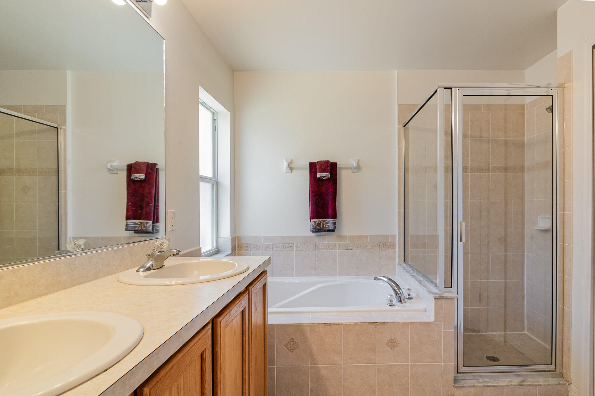 1391 Saxony Road Southwest Palm Bay, FL 32908 - Photo 18 of 28 a bathroom with a granite countertop tub sink and mirror