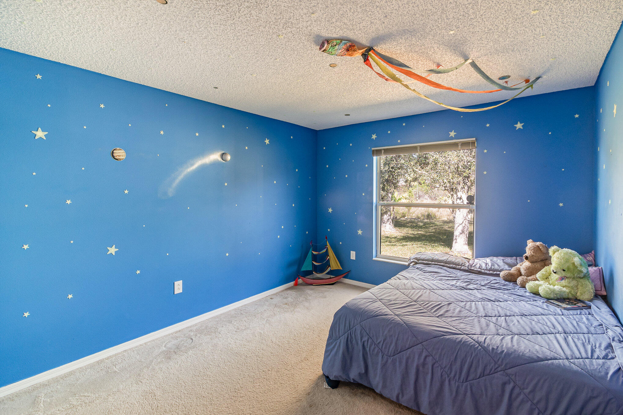 1391 Saxony Road Southwest Palm Bay, FL 32908 - Photo 19 of 28 a bedroom with a bed and a window