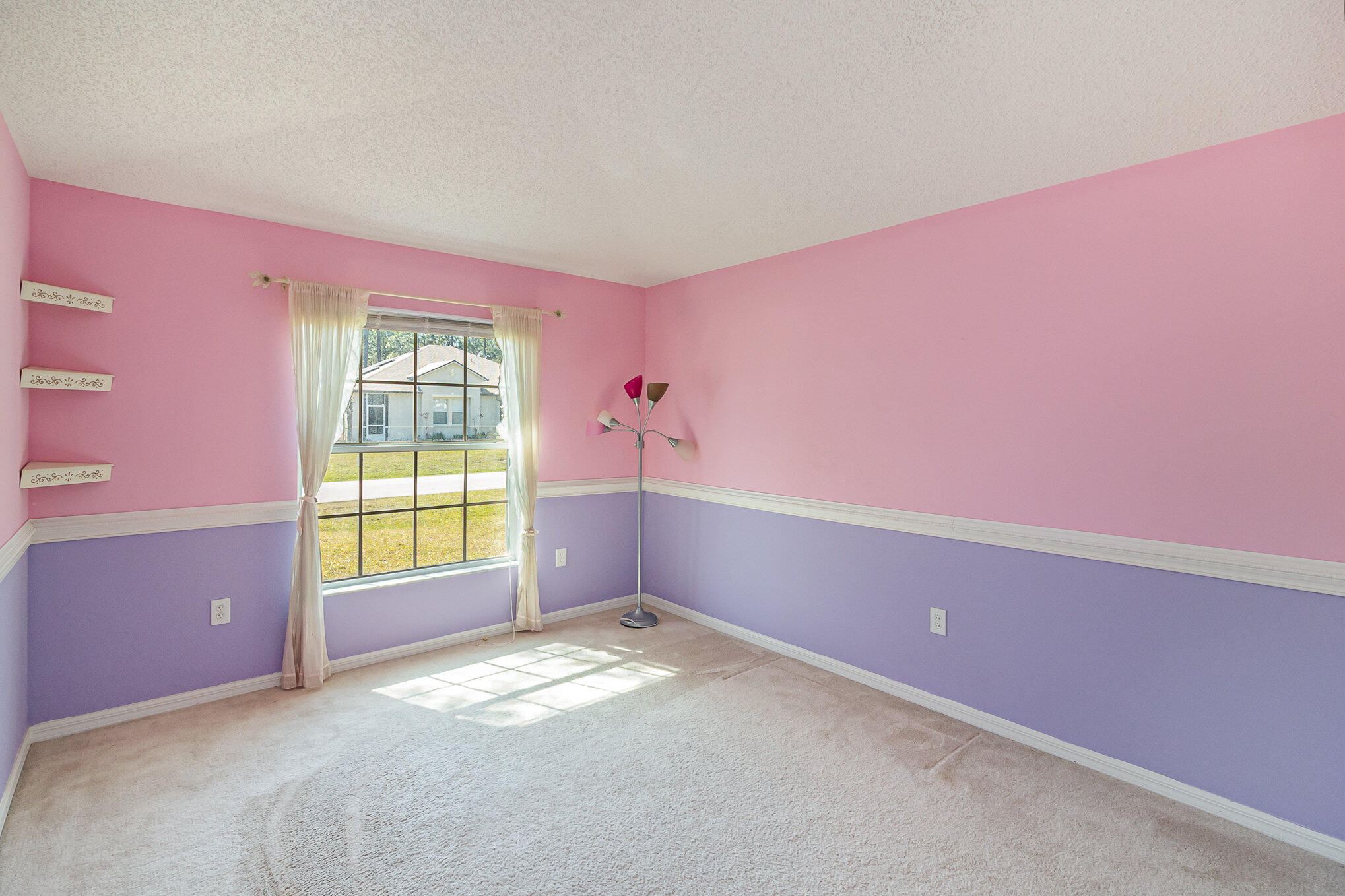 1391 Saxony Road Southwest Palm Bay, FL 32908 - Photo 20 of 28 a view of an empty room with a window