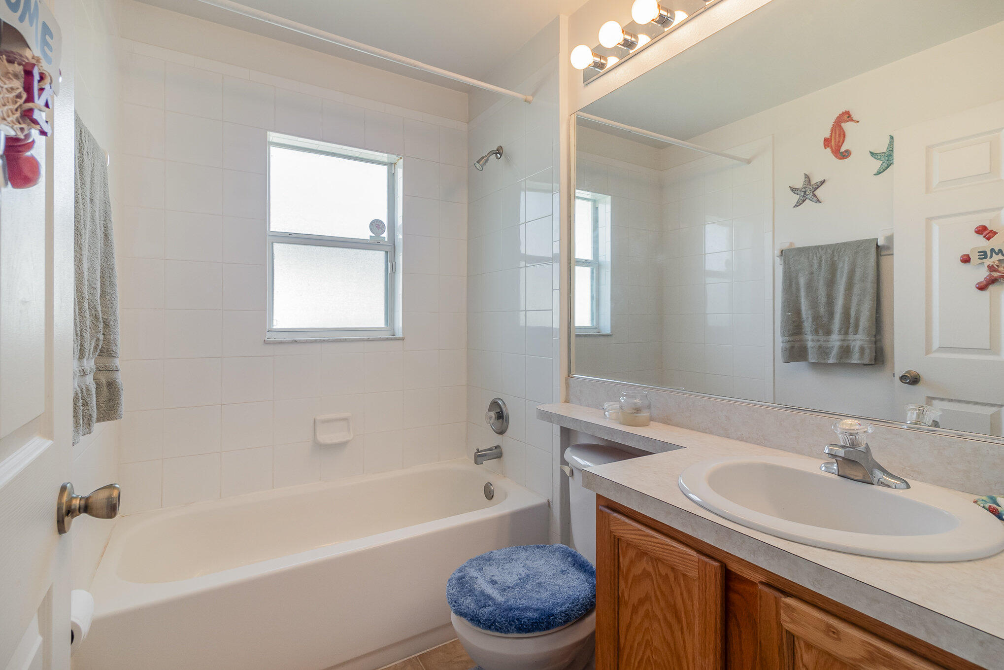 1391 Saxony Road Southwest Palm Bay, FL 32908 - Photo 21 of 28 a bathroom with a sink toilet tub and shower