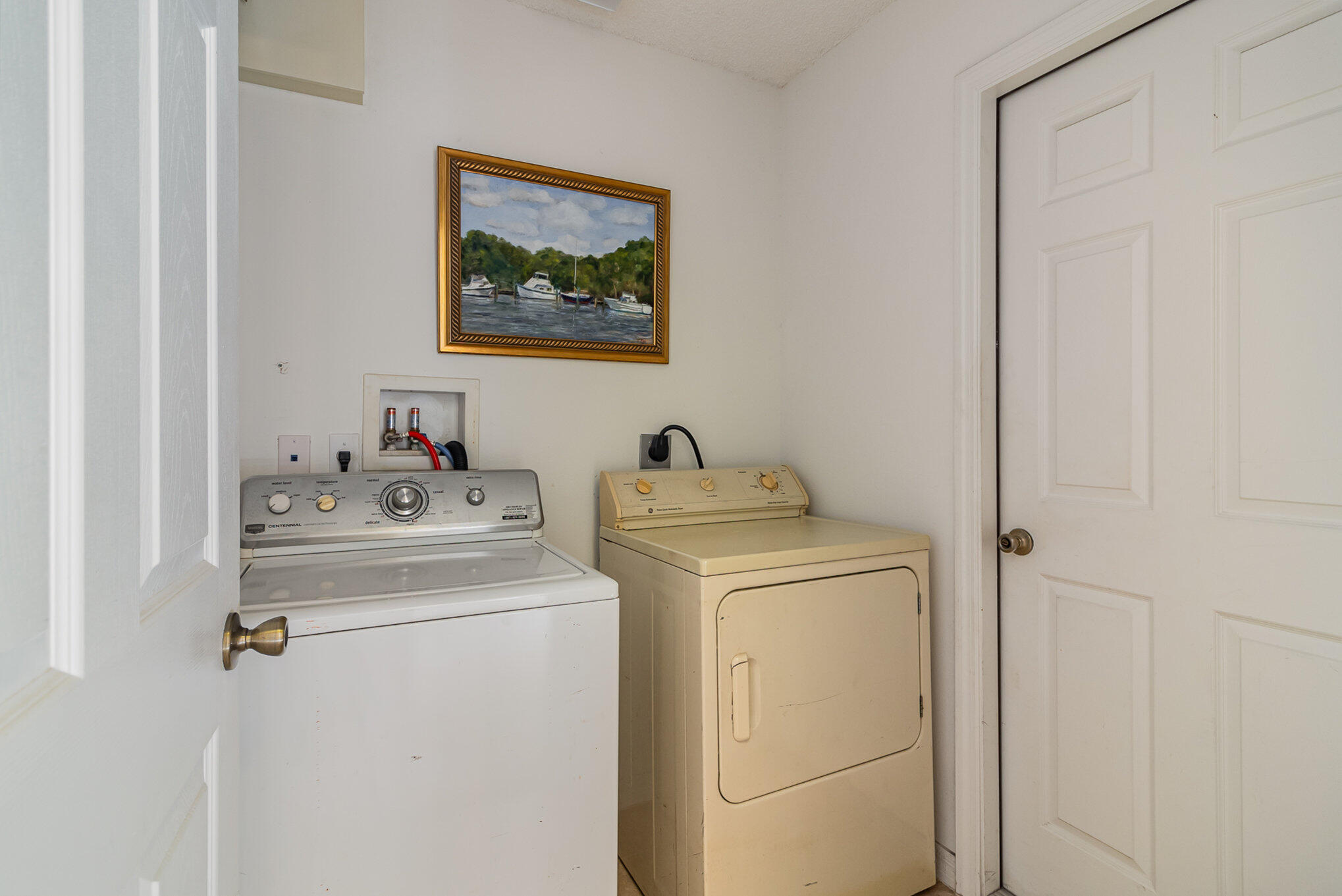 1391 Saxony Road Southwest Palm Bay, FL 32908 - Photo 22 of 28 a view of storage and utility room with washer and dryer