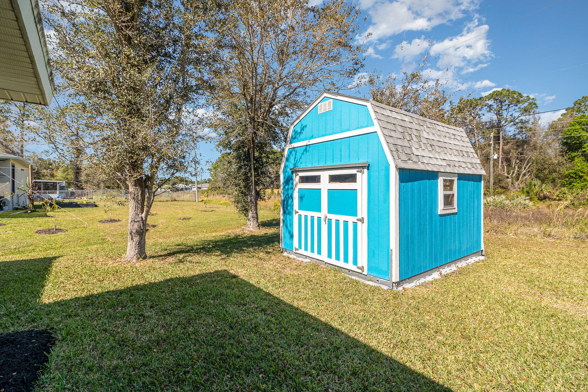 1391 Saxony Road Southwest Palm Bay, FL 32908 - Photo 27 of 28 a front view of a house with a yard