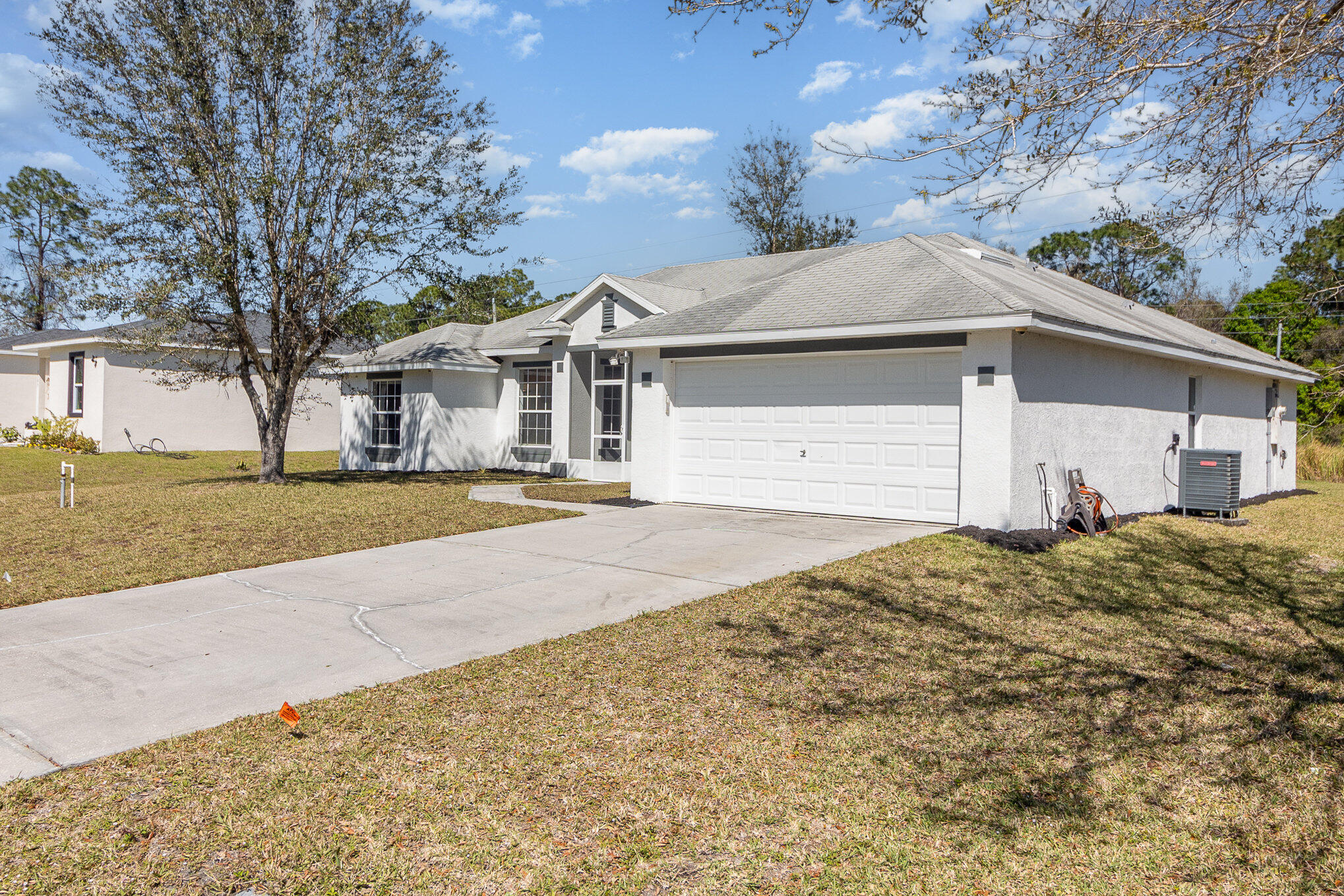 1391 Saxony Road Southwest Palm Bay, FL 32908 - Photo 3 of 28 a front view of house with yard