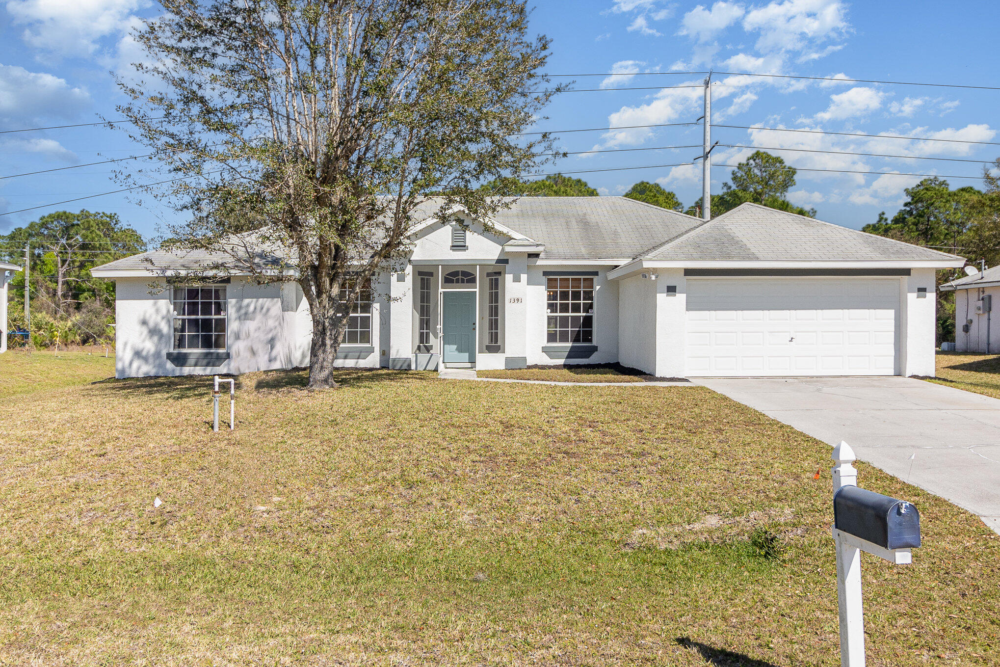 1391 Saxony Road Southwest Palm Bay, FL 32908 - Photo 4 of 28 a front view of a house with a yard