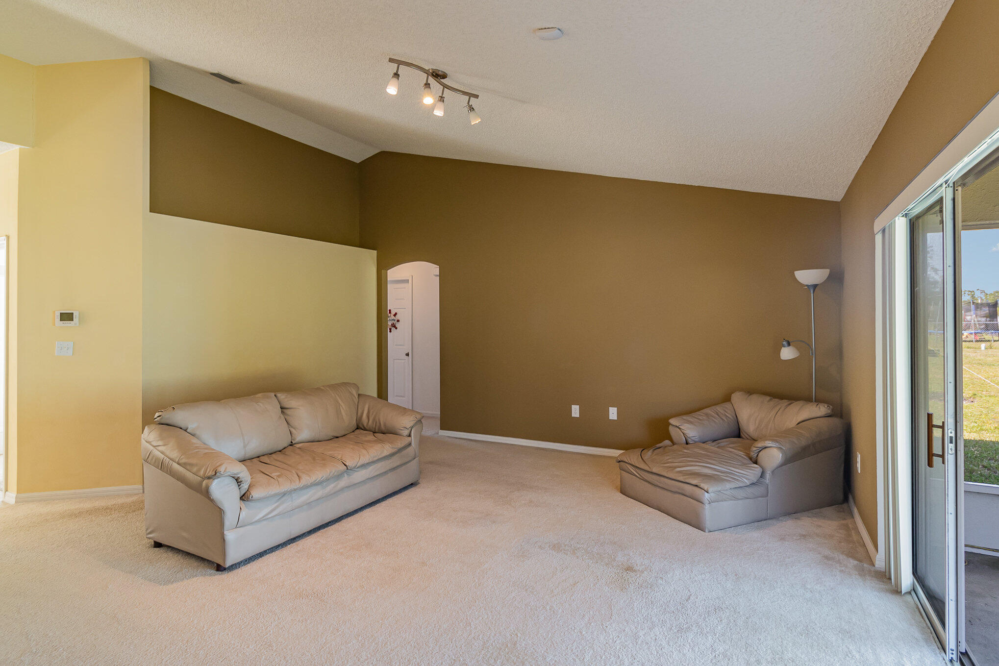 1391 Saxony Road Southwest Palm Bay, FL 32908 - Photo 7 of 28 a living room with furniture and a couch