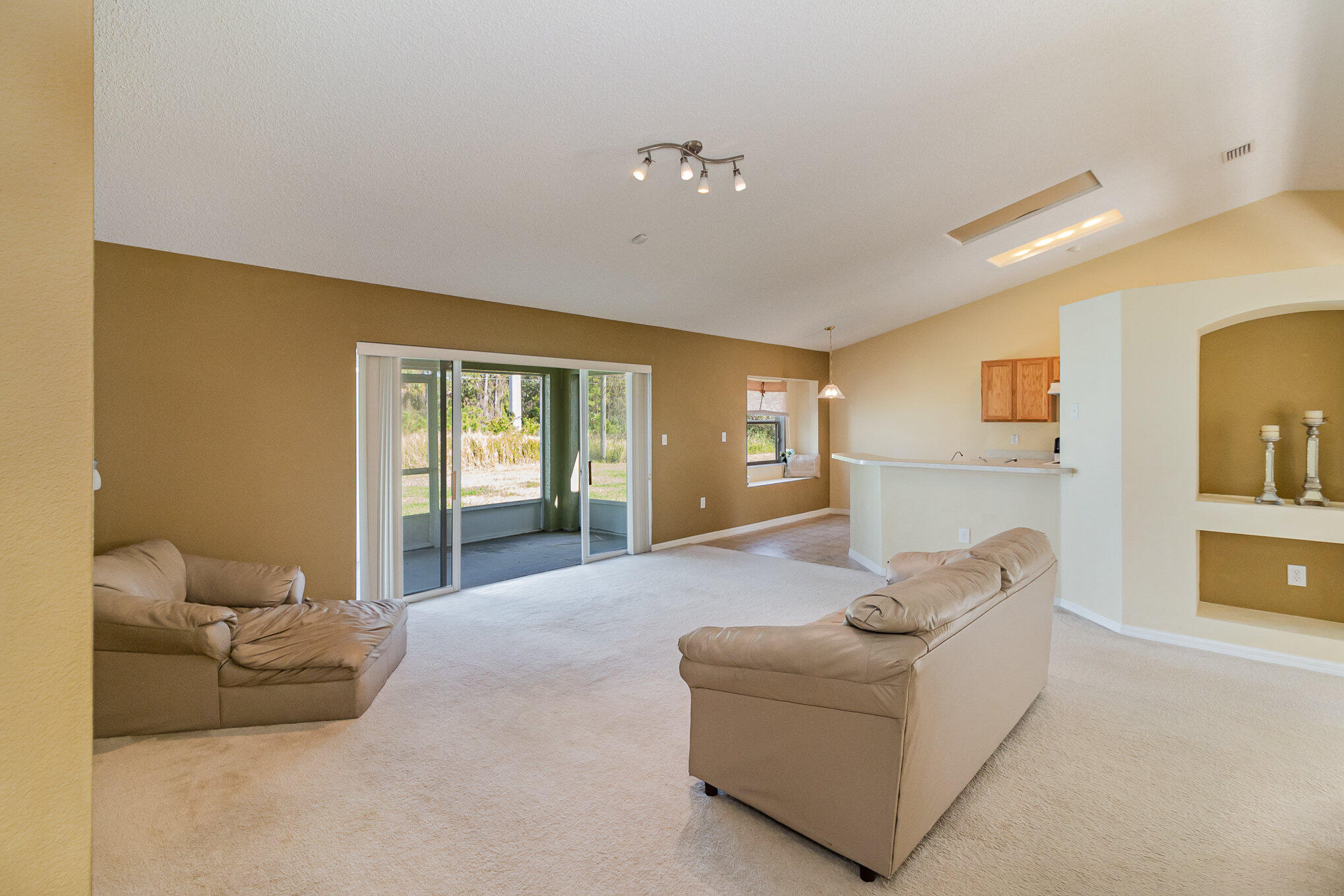 1391 Saxony Road Southwest Palm Bay, FL 32908 - Photo 8 of 28 a living room with furniture and window