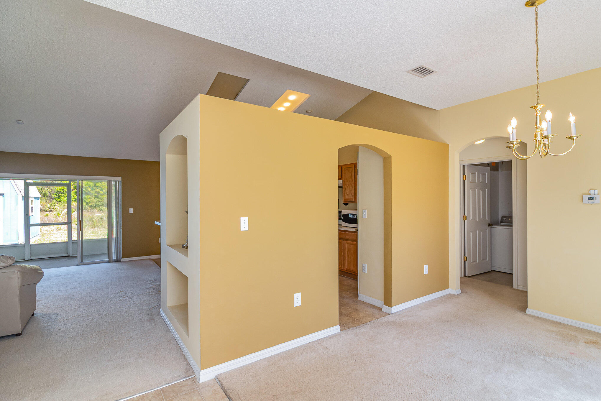 1391 Saxony Road Southwest Palm Bay, FL 32908 - Photo 9 of 28 a view of a livingroom with a chandelier