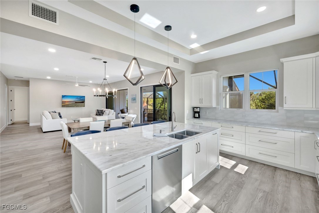 a large white kitchen with a lot of counter space