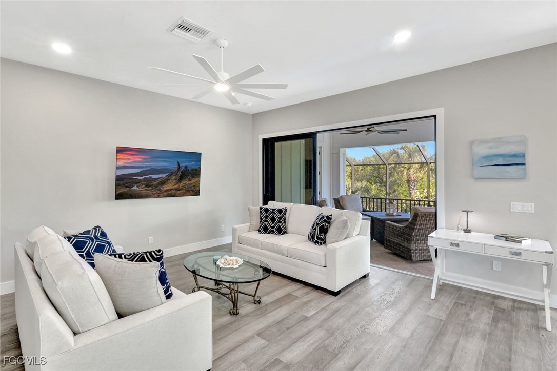 1044 Fish Crow Road Sanibel, FL 33957 - Photo 12 of 36 a living room with furniture and a large window
