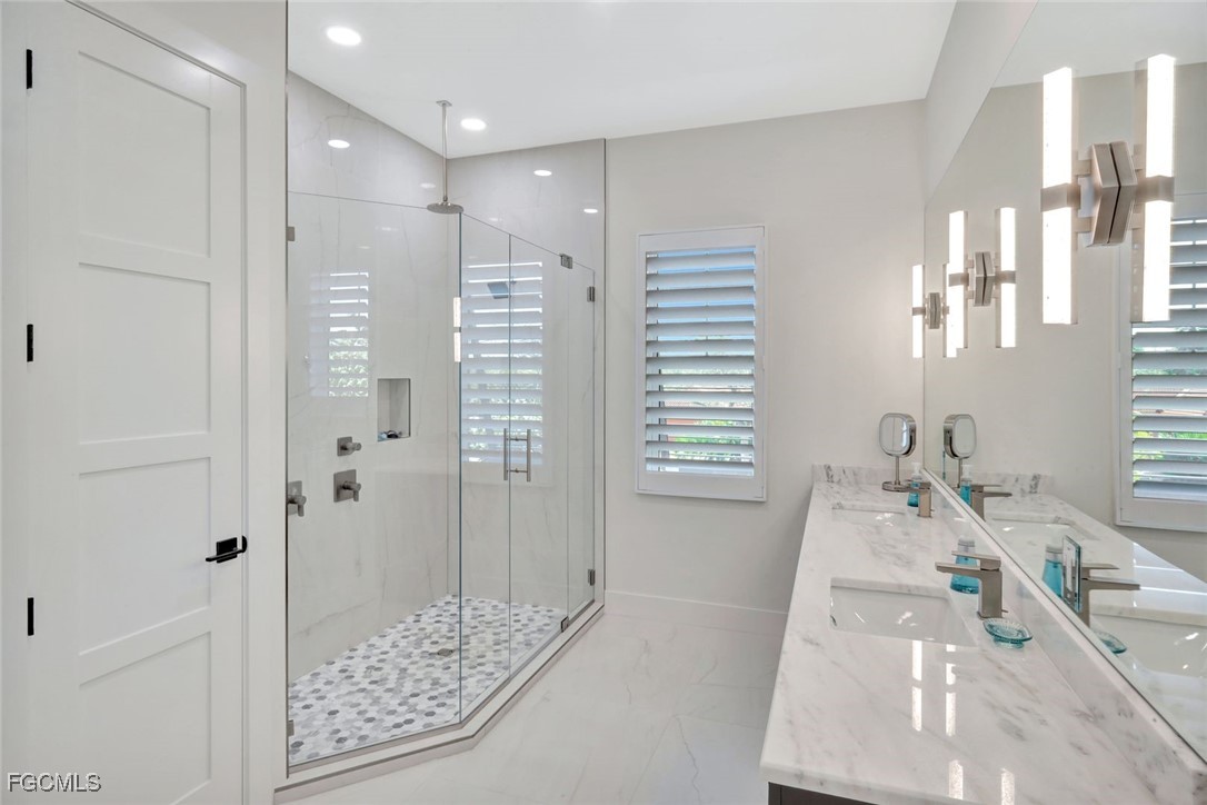 1044 Fish Crow Road Sanibel, FL 33957 - Photo 19 of 36 a bathroom with a tub shower and sink