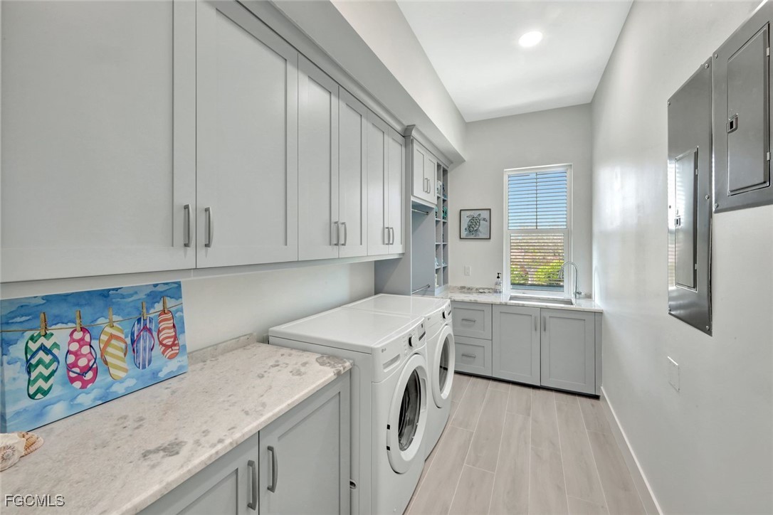 1044 Fish Crow Road Sanibel, FL 33957 - Photo 20 of 36 a utility room with cabinets washer and dryer