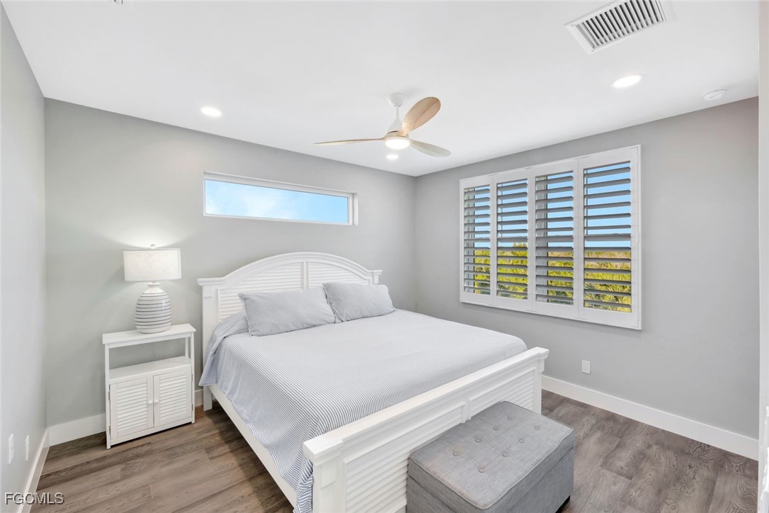 1044 Fish Crow Road Sanibel, FL 33957 - Photo 25 of 36 a bedroom with a bed and a window