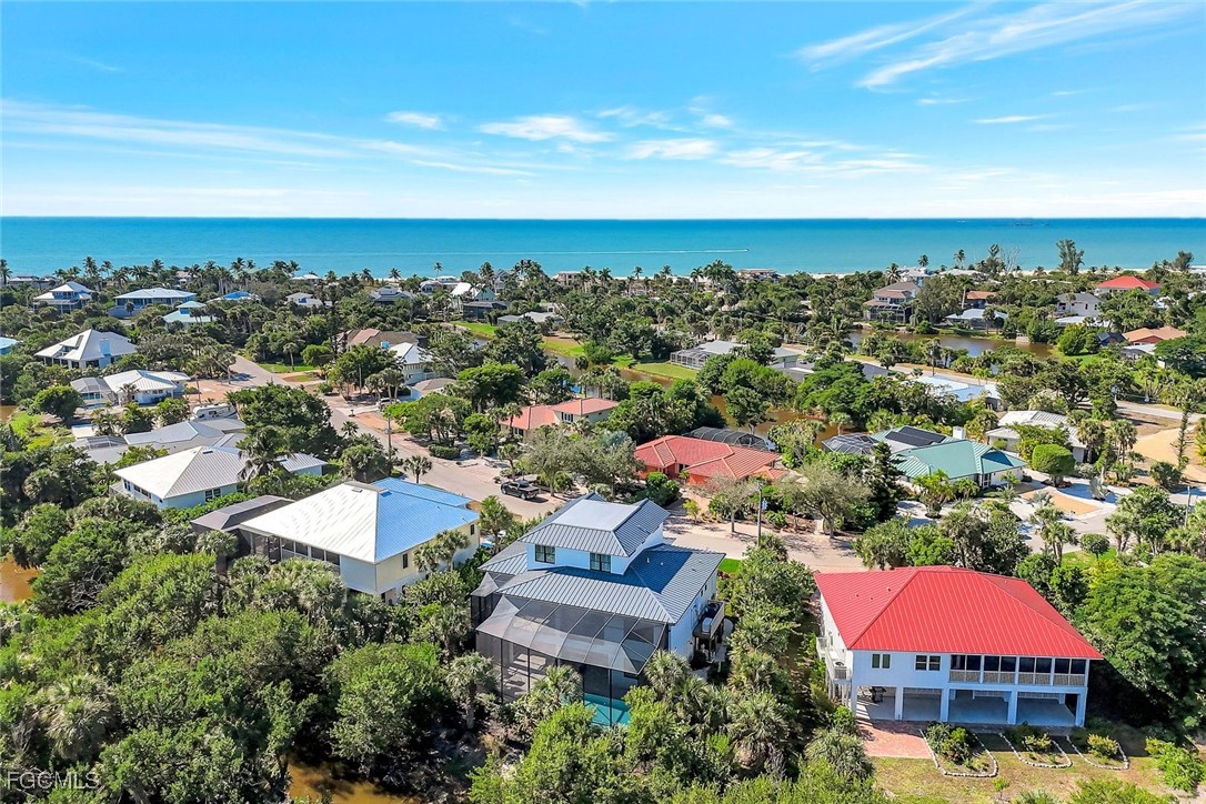 1044 Fish Crow Road Sanibel, FL 33957 - Photo 3 of 36 an aerial view of a houses with a swimming pool