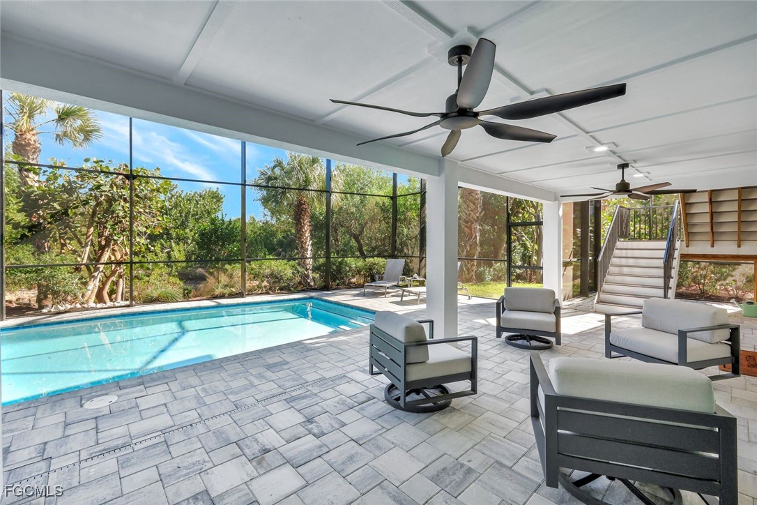 1044 Fish Crow Road Sanibel, FL 33957 - Photo 35 of 36 a living room with patio furniture and a floor to ceiling window