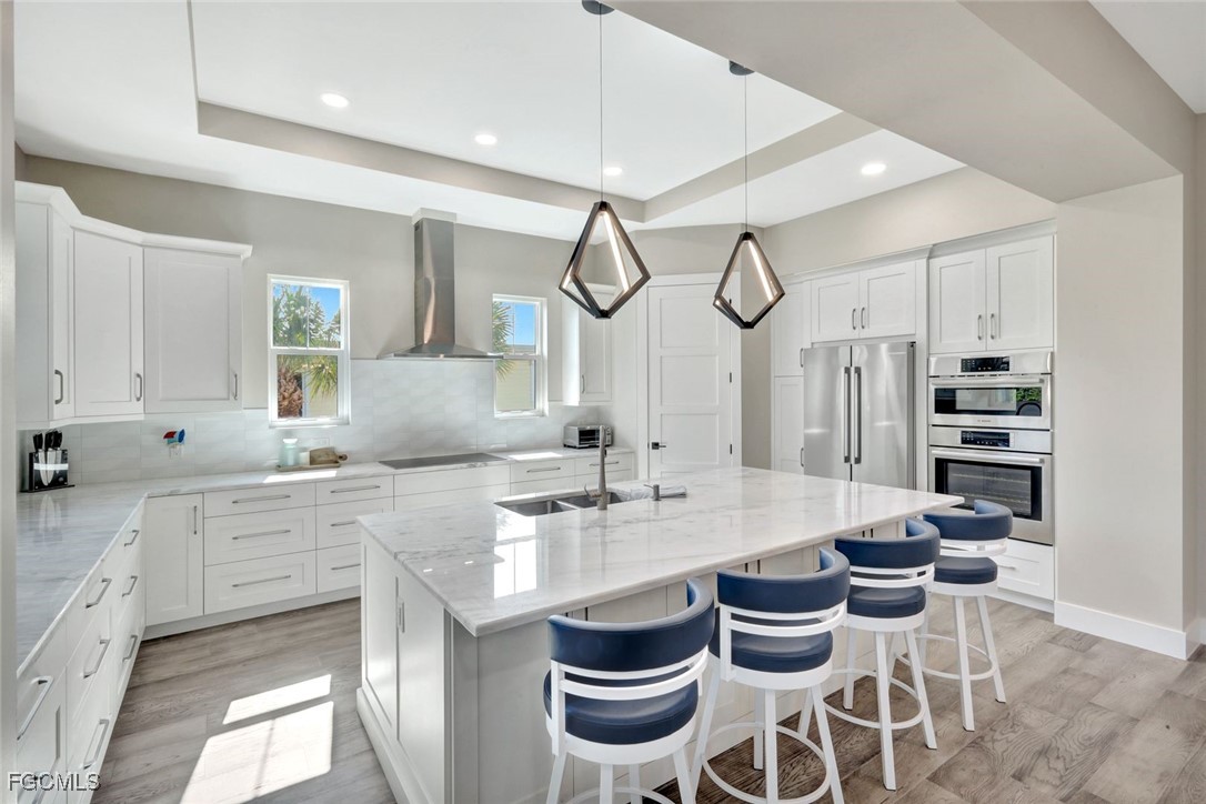 1044 Fish Crow Road Sanibel, FL 33957 - Photo 8 of 36 a kitchen with stainless steel appliances kitchen island a table and chairs in it