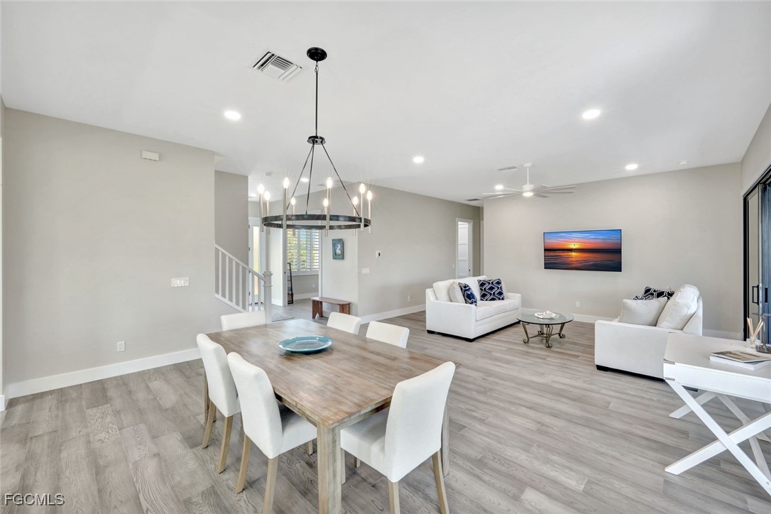 1044 Fish Crow Road Sanibel, FL 33957 - Photo 10 of 36 a view of a dining room with furniture a chandelier and wooden floor