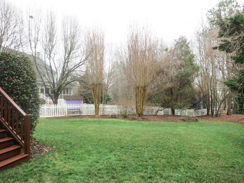 9305 Dawnshire Road Raleigh, NC 27615 - Photo 23 of 25 The park-like backyard is surrounded by trees. Backyard