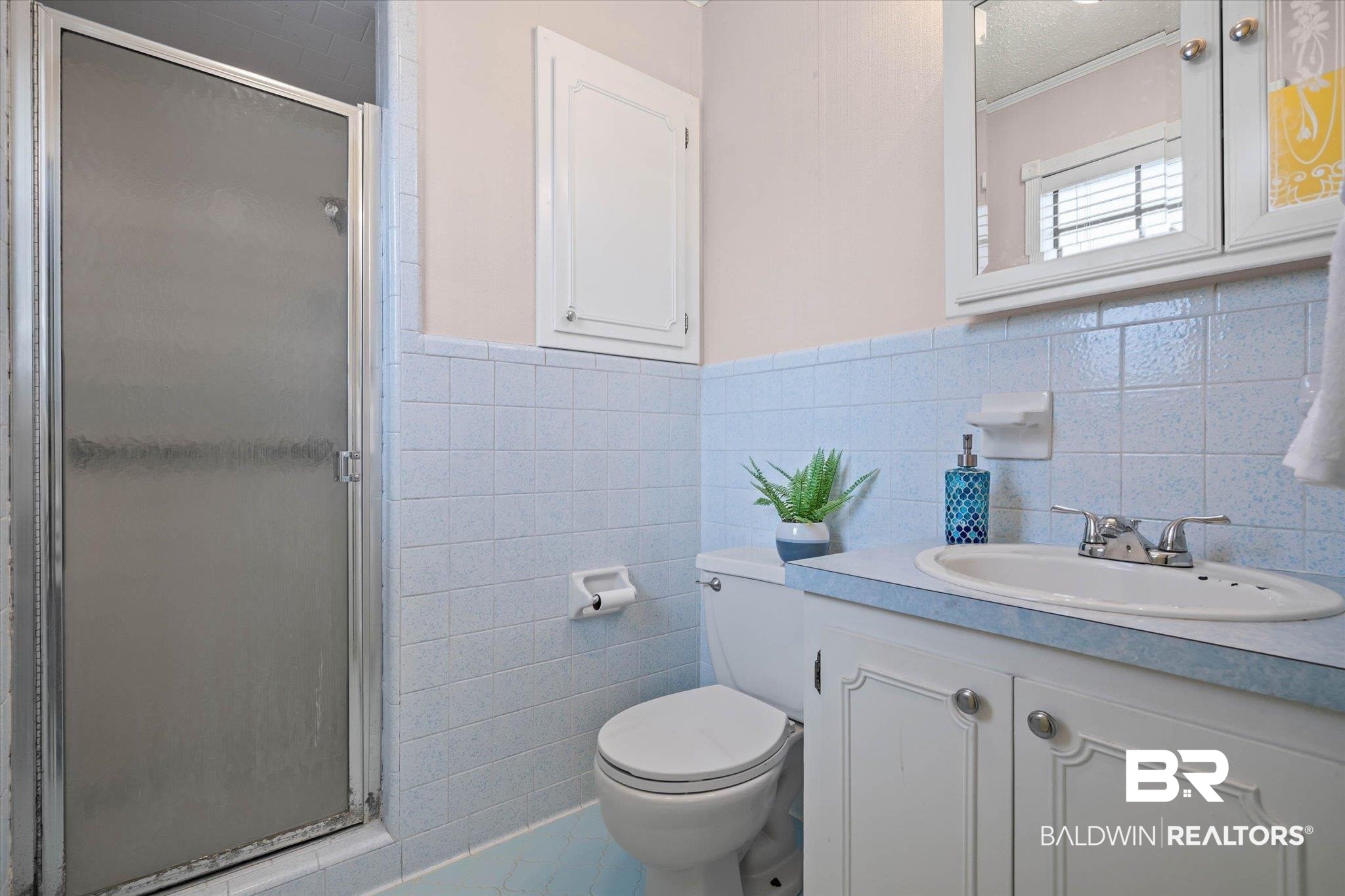 8090 Murray Hill Road Irvington, AL 36544 - Photo 22 of 40 Bathroom with wainscoting, vanity, a stall shower, and tile walls