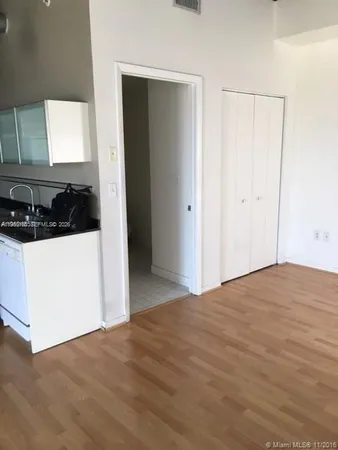 a view of a kitchen with a sink and a refrigerator