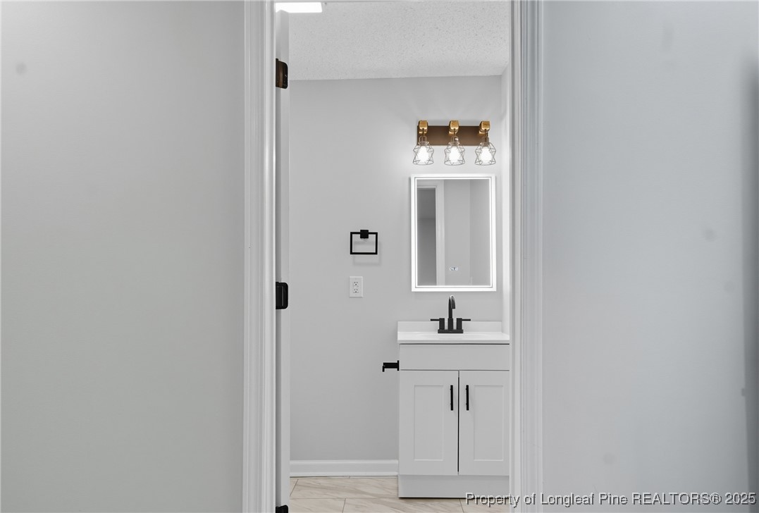 8306 Godwin-Falcon Road Godwin, NC 28344 - Photo 38 of 50 a bathroom with a sink and a mirror