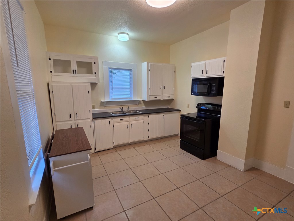 1214 South 11th Street Temple, TX 76504 - Photo 12 of 23 a kitchen with stainless steel appliances a refrigerator sink and cabinets