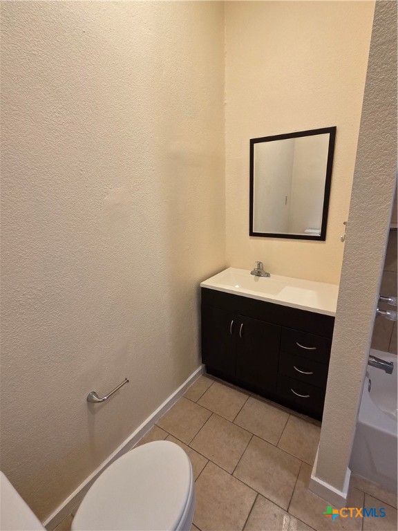 1214 South 11th Street Temple, TX 76504 - Photo 16 of 23 a bathroom with a toilet sink and mirror