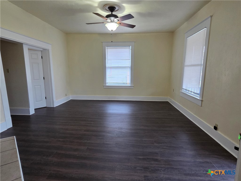 1214 South 11th Street Temple, TX 76504 - Photo 5 of 23 a view of an empty room with wooden floor and a window