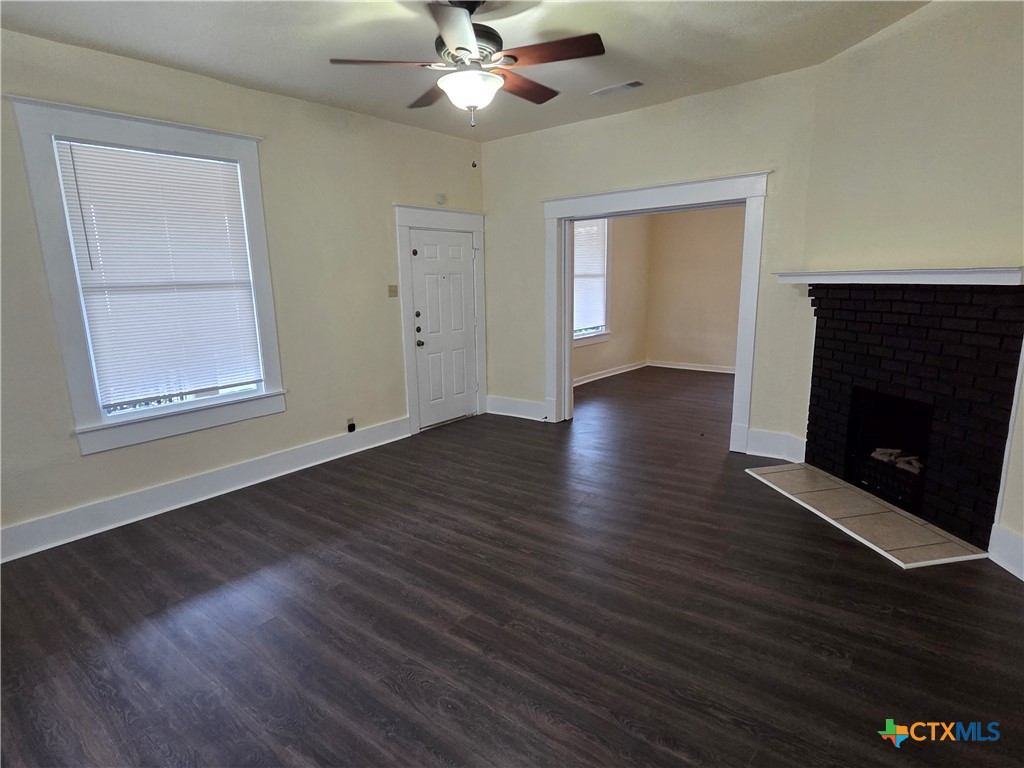 1214 South 11th Street Temple, TX 76504 - Photo 6 of 23 a view of an empty room with wooden floor and a window